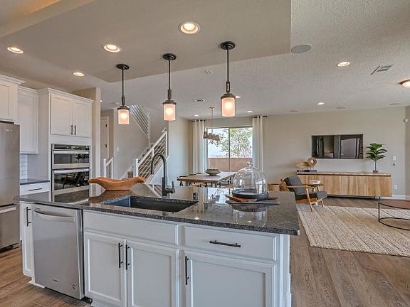 The kitchen overlooks the cafe and gathering room, offering a bright and open feel to the home desig