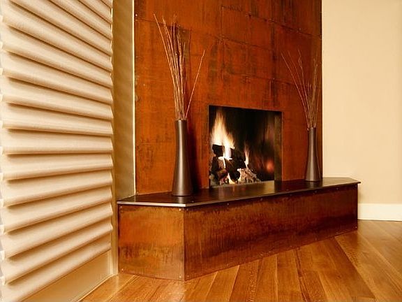 Custom rusted steel fireplace designed by Paolo Cividino