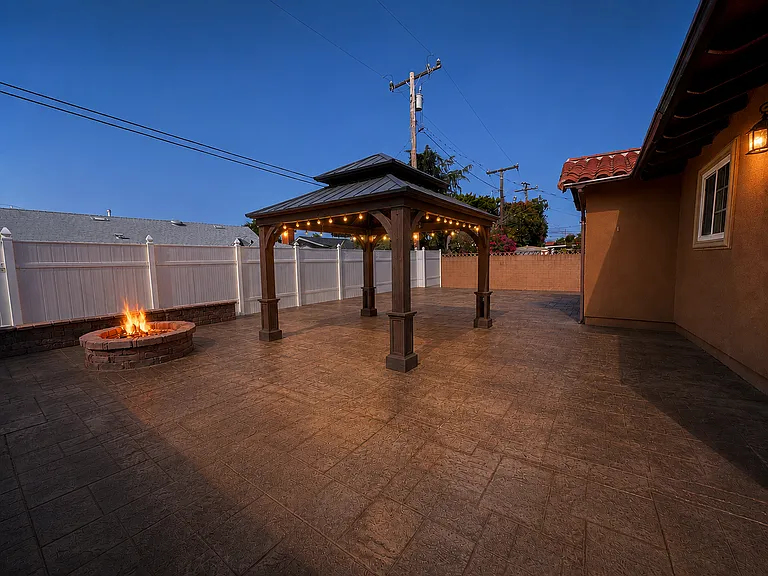 The spacious backyard includes a dedicated gas line hookup for easy outdoor grilling.