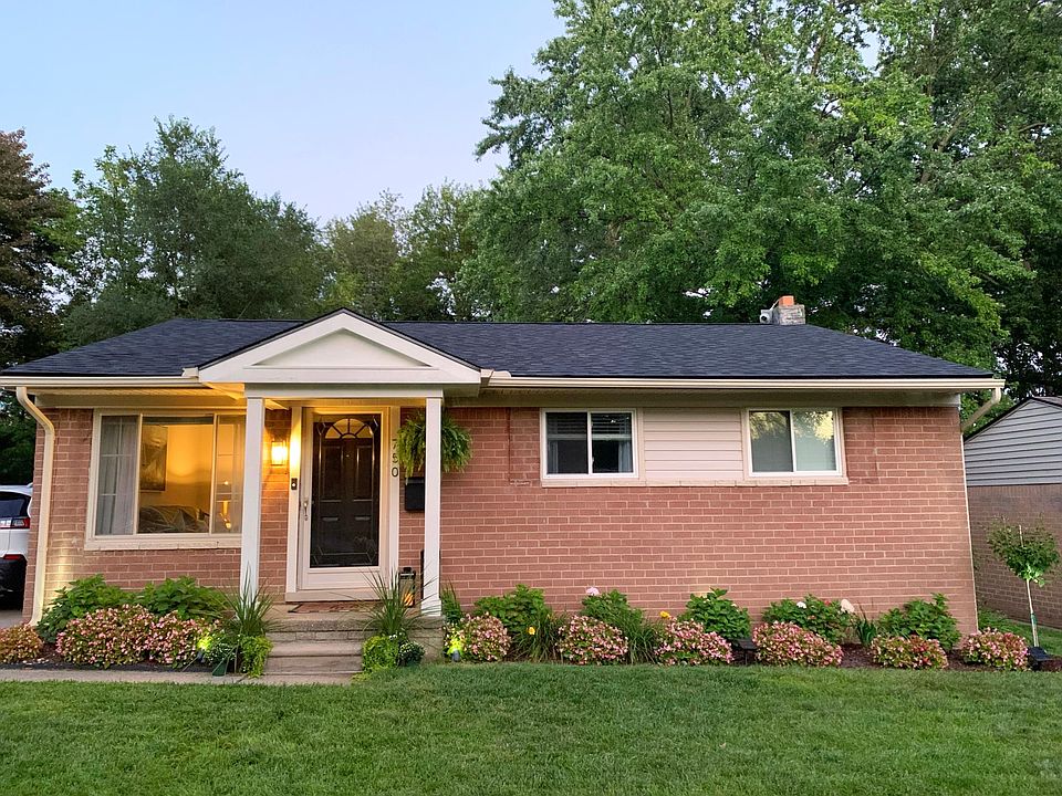 New roof, elegant dormer, modern landscaping, and updated lights.