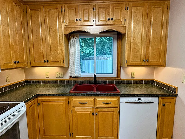Beautifully updated kitchen, Custom Maple Cabinetry. All kitchen appliances and upgraded HE Washer/Dryer included.