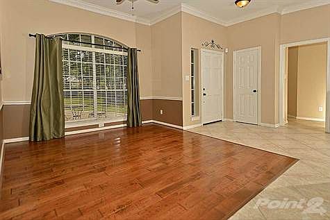 Entry way is open with dedicated formal dining where the wood floors are.