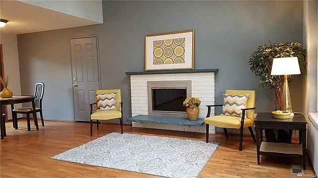 Fireplace and the door to 2 car garage