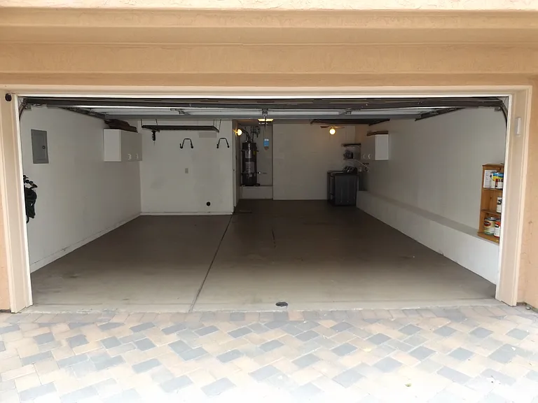 Two and a half garage with extra ceiling racks storage and laundry