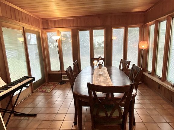 Family room has sliding door to backyard and 2 walls of crank out windows. Tile floor. Cedar walls and ceiling. This tenant used the room as a dining room however there is a good size dining room off the kitchen.