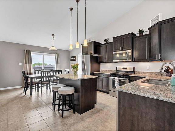 Beautiful kitchen with granite counter tops, center island, stainless steel appliances, gas range, staggered 42 inch upgraded ca