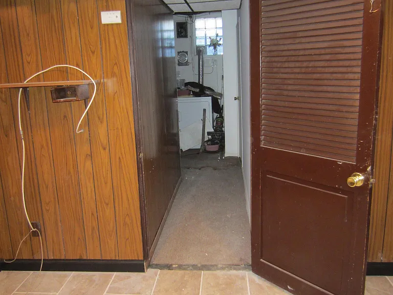 Hall beyond door leads to laundry area, 1/2 bath, bonus room and back door.
