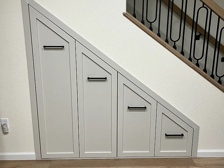 Slide out storage under stairs.