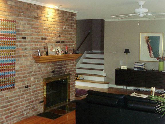 Brick Wall Living Room with Wood Burning Fireplace