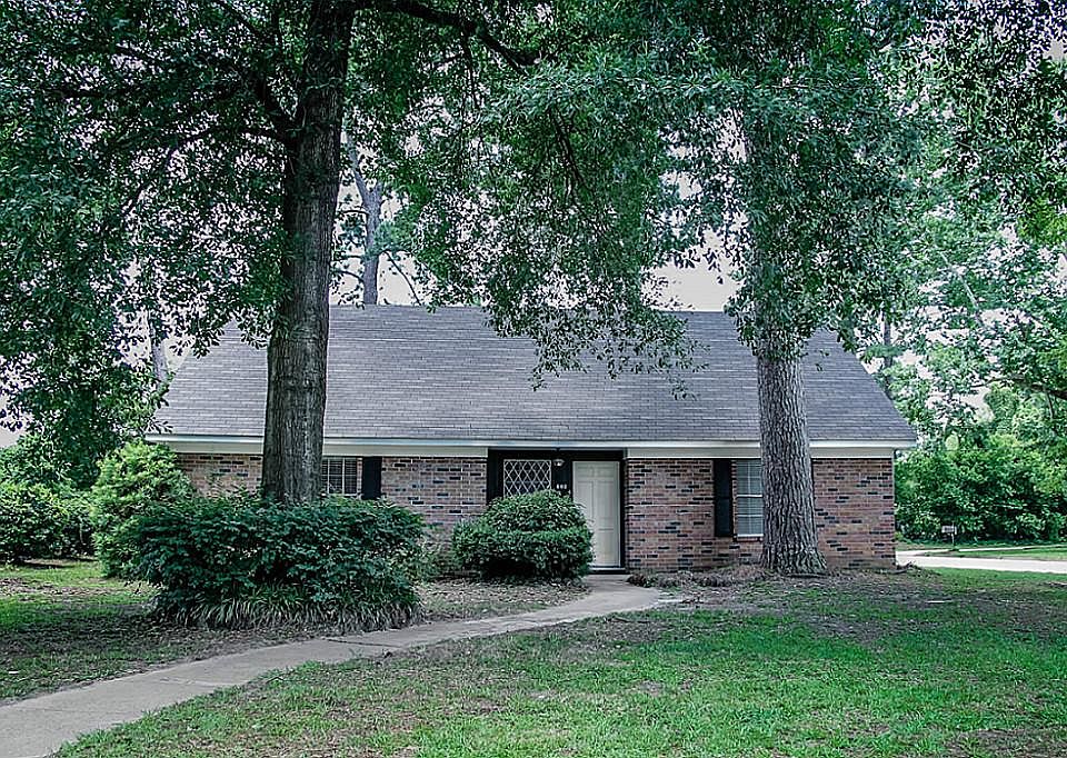 Front of house on beautiful treed lot.