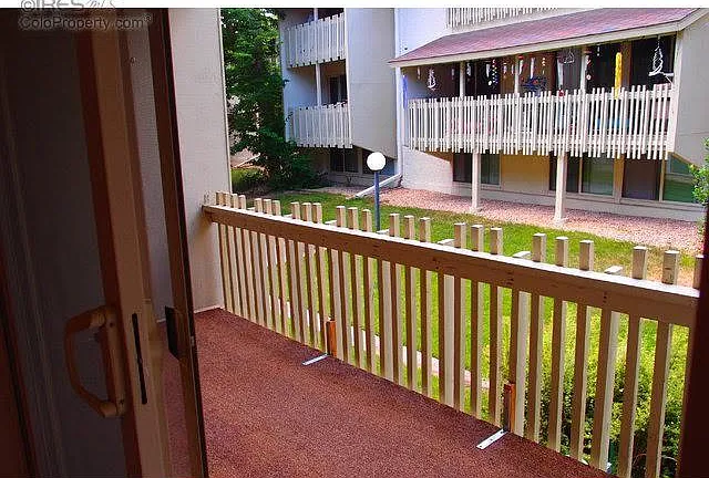Looking out over the balcony to a green courtyard.