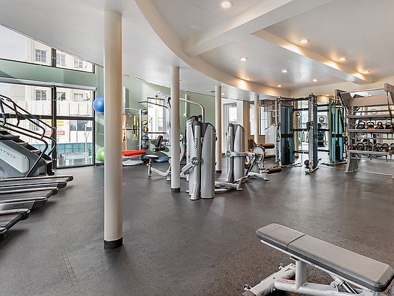 Fitness center with cardio and strength training equipment.