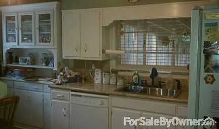 Kitchen that looks onto porch
						:
						All appliances are white. Sink, countertops, and cooktop are new.