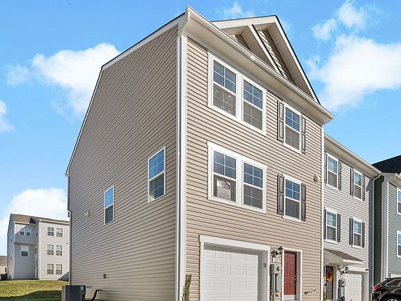Side exterior view of York II floor plan at Kings Crossing Townhomes by DRB Homes, located in Charle