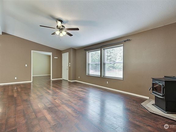 View from family room to entry, note lovely flooring and office/den as you walk in to your right. Pellet stove keeps you warm in the cooler winter nights. >