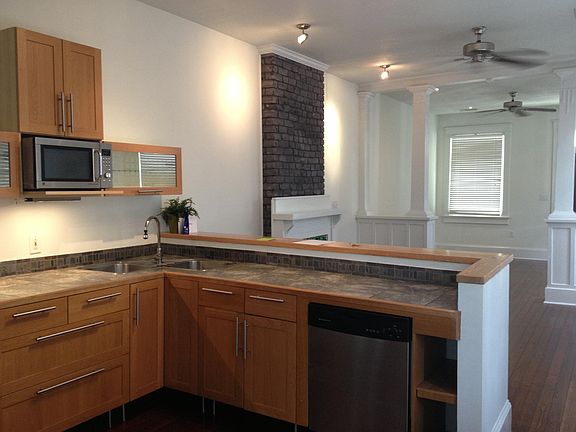 Kitchen looks on to the living and dinning areas. Pictured here are the dueling sinks, dish washer as well as the ample cabinet and counter space.