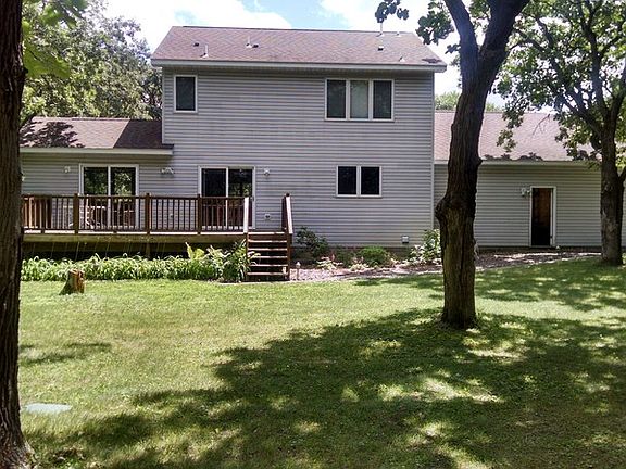 Back view from half way in the back yard : The serenity of the back yard with trees bordering both s