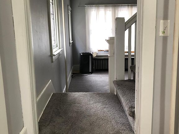 View from dining room across two way staircase into living room
