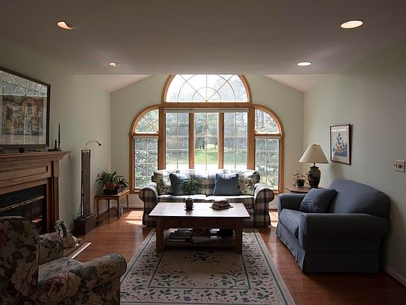 Living Room filled with natural light and wood burning fireplace