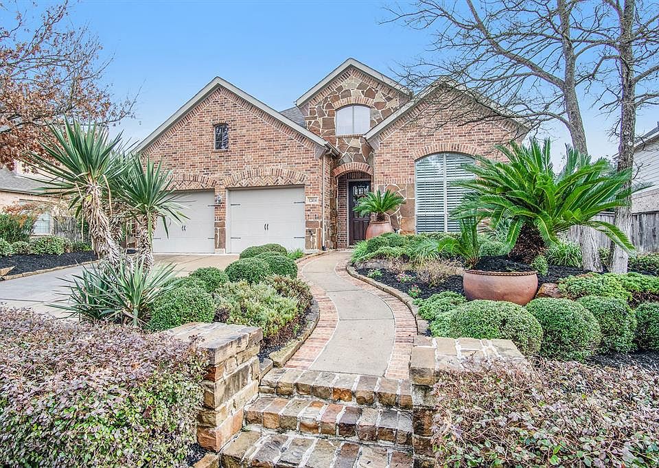 WOW! Look at this homes beautifully landscaped front entrance.