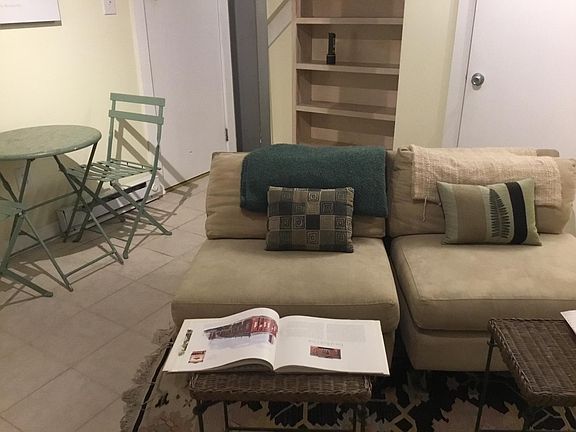 Living area (the chairs are available for your use. Ikea has a couple of smaller kitchen/DR tables which work in the space. The door on the left leads to the laundry closet; the book shelf has housed books, groceries. Make it your own. The door on the rig