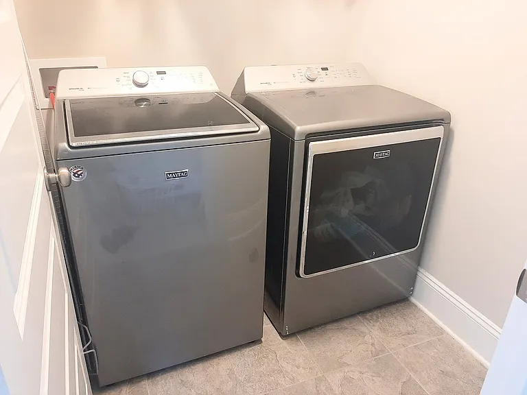 Laundry room with shelf storage.