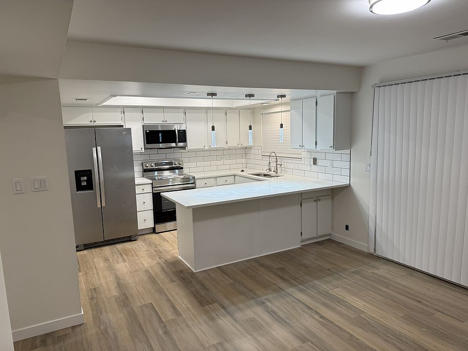 Luxury modern kitchen with brand new stove and microwave. Brand new flooring, new paint throughtout the home.