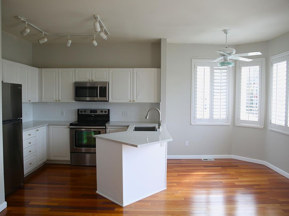Open kitchen with new quartz countertops and sink installed in 2022