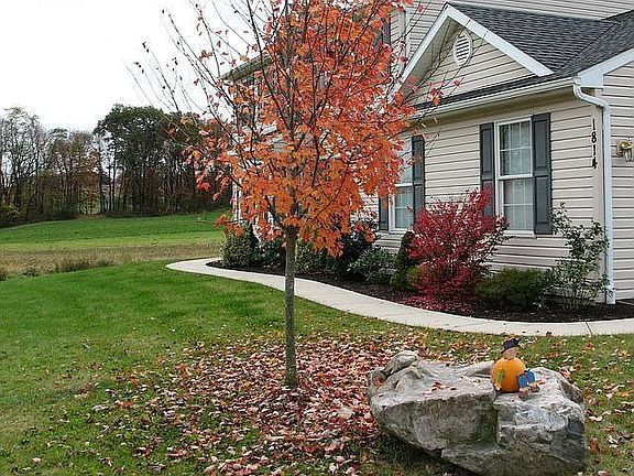 Looking at the front of the house and curvy sidewalk