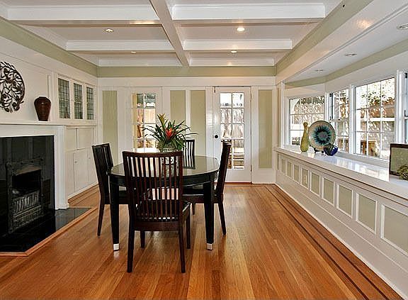 Generous formal dining room w/ fireplace, boxed-beam ceiling  & hardwood floor