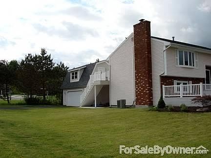 Back view of house, patio, garage