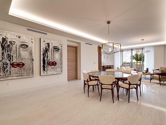 The open Great Room shows the generous width of 17 'and length 37' long of the Great Room containing the Livingroom and Diningroom. Looking out thru the 9'9" high sliding glass doors and 12' wide, you can see the tops of the Palm Trees that are on Pool-