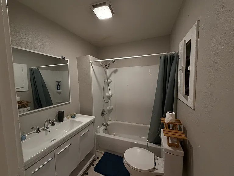 Main bathroom with tub and vanity