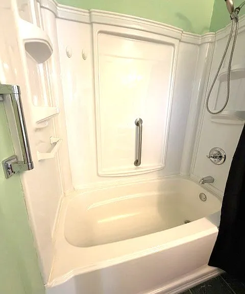 Tub in master bath has grab bars for safe entry and exit into tub.
