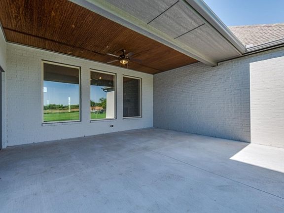 Large covered back patio overlooking 1 2 acre lot at a Landmark Fine Home