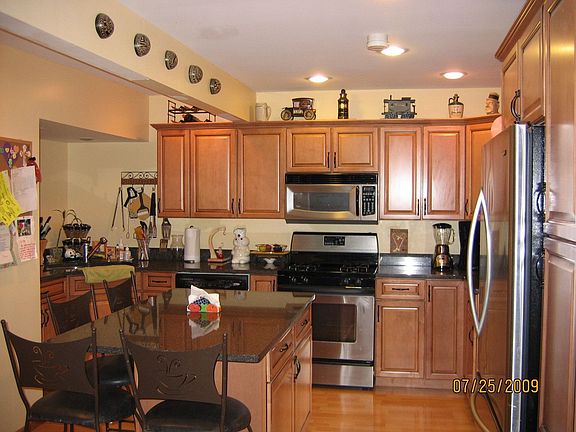 Island kitchen with custom cabinets, stainless appliances