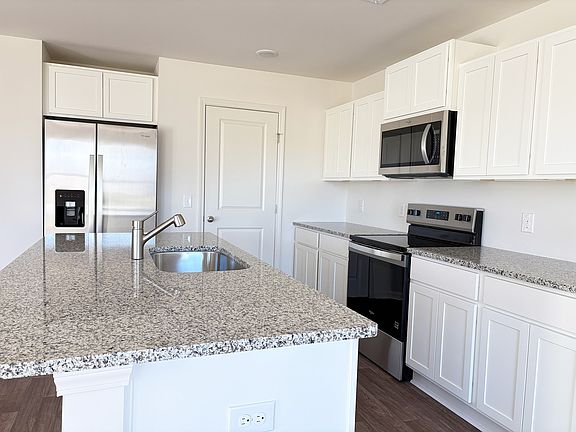 Kitchen view with new appliances and granite countertops