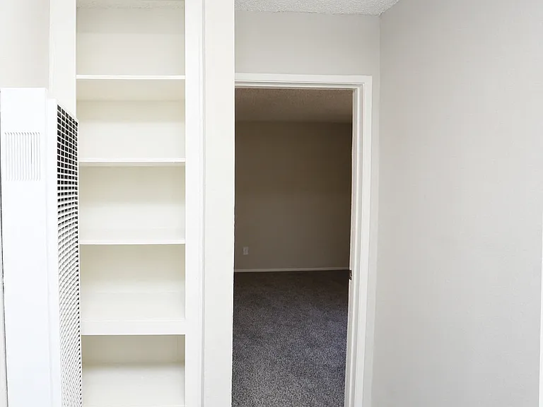 View of hallway linen storage closet.