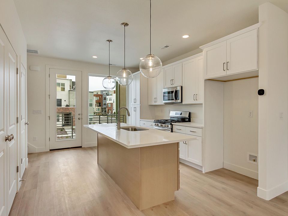 Kitchen with white cabinets and center island in a sego home