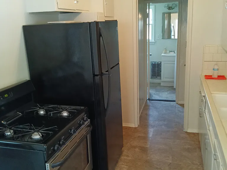 Newer appliances with bathroom in background