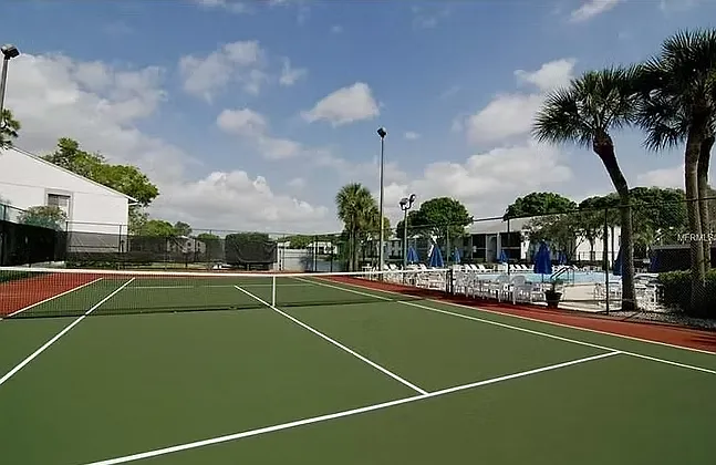 Tennis court next to pool