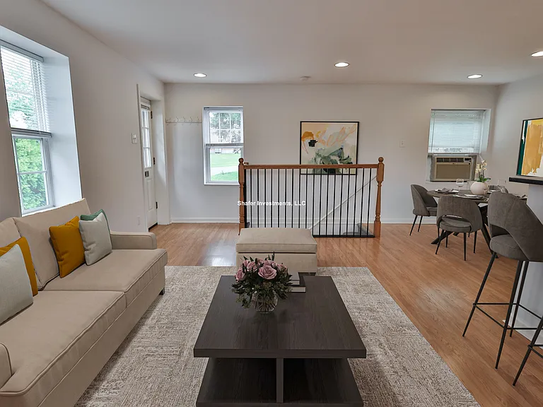 Virtually staged view of the great room facing the stairs