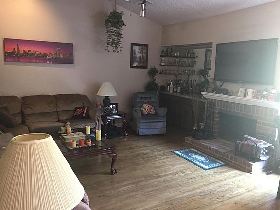 Family Room overlooking creek with fireplace and wood floors