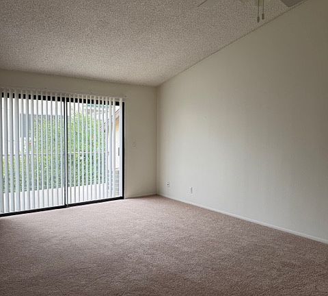 Living Room with Sliding Glass Door out to Balcony.