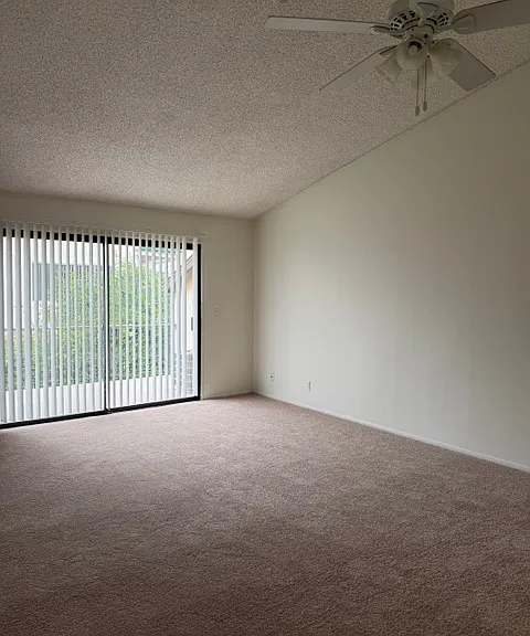 Living Room with Sliding Glass Door out to Balcony.