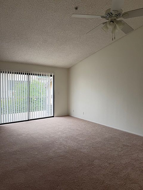 Living Room with Sliding Glass Door out to Balcony.