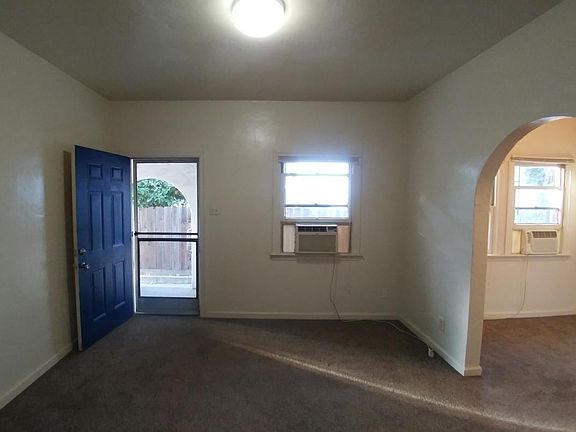 Bedroom is through an open archway.