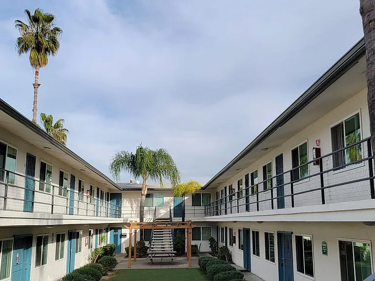 Upper apartment view of courtyard at Orlando Woods Apartments in El Cajon, California.