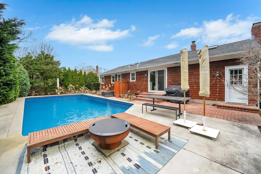  Backyard oasis, with inground pool, lounge chairs, outdoor dining, umbrellas, grill, fire pit, and o