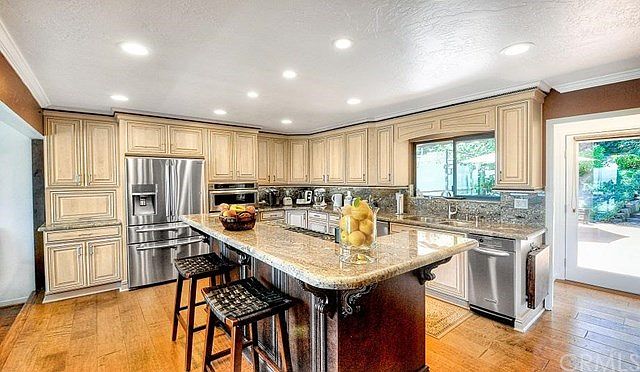 Gorgeous kitchen opens up to the living room, dining room and the backyard area